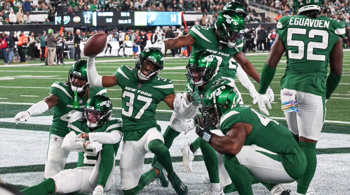 The Jets celebrate in the end zone as a team during a win over the Eagles